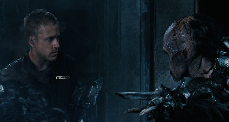Pandorum 2009 Movie Scene Ben Foster as Bower looking at the mutant holding a spear through the force field
