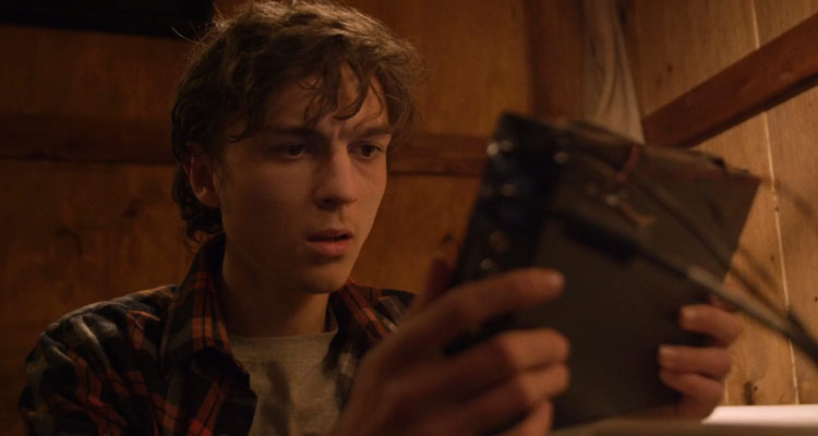 Blood Punch 2014 Movie Milo Cawthorne as Milton looking at a message