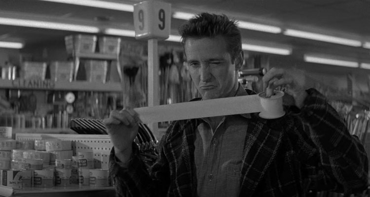 In Cold Blood Movie 1967 Scene Scott Wilson as Dick Hickock holding a duct tape in a store before the robbery and winking