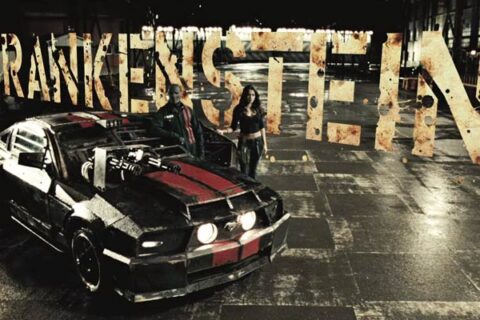 Death Race 2008 Movie Scene Jason Statham as Jensen Ames AKA Frankenstein and Natalie Martinez as Case standing next to their car a 2006 Ford Mustang GT with Gatling guns