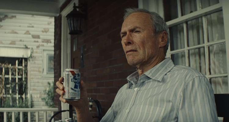 Gran Torino 2008 Movie Scene Clint Eastwood as Walt Kowalski drinking beer and smoking on his porch