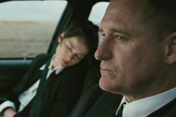 Surveillance 2008 Movie Scene Bill Pullman as Sam driving the car while Julia Ormond as Elizabeth is sleeping