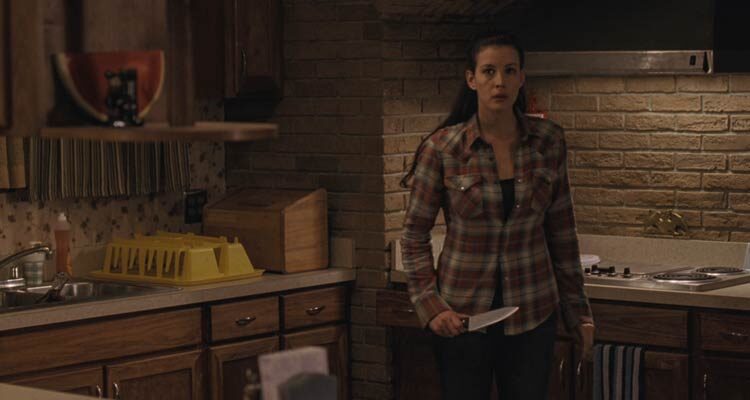 The Strangers 2008 Movie Scene Liv Tyler as Kristen holding a knife to fight off any intruders into her home