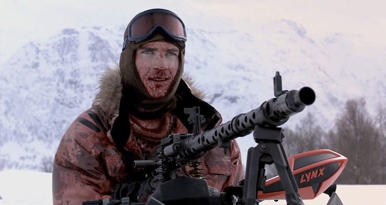 Dead Snow 2009 Movie Lasse Valdal as Vegard firing a German heavy machine gun MG 32 mounted on top of his snowmobile