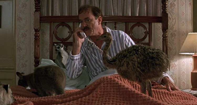 Fierce Creatures 1997 Movie Scene John Cleese as Rollo Lee talking over the phone in his bed with a bunch of cute animals all around him