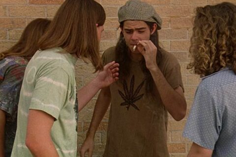 Dazed and Confused 1993 Movie Scene Rory Cochrane as Slater smoking a joint in front of his high school with friends