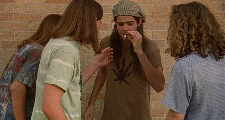 Dazed and Confused 1993 Movie Scene Rory Cochrane as Slater smoking a joint in front of his high school with friends