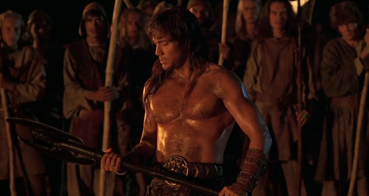Kull The Conqueror 1997 Movie Scene Kevin Sorbo as Kull showing his muscles and holding a big axe