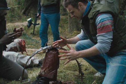 Severance 2006 Movie Scene Danny Dyer as Steve looking at an amputated foot of his coworker in a bear trap during their team building
