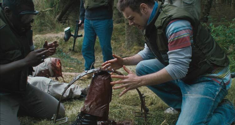 Severance 2006 Movie Scene Danny Dyer as Steve looking at an amputated foot of his coworker in a bear trap during their team building