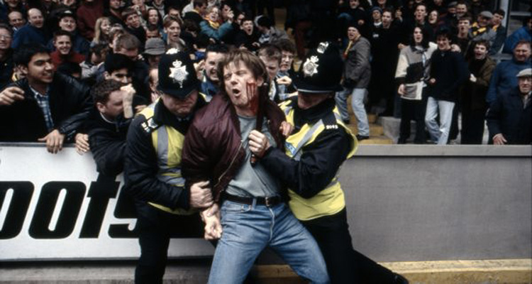 ID 1995 Movie Reece Dinsdale with a bloody cheek getting carried away by two policeman at the stadium after an incident