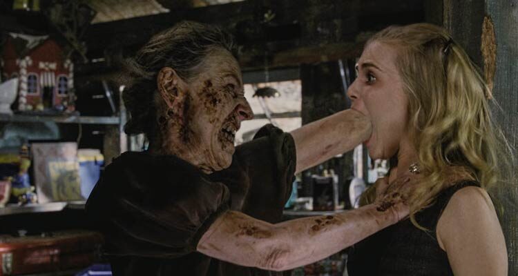 Drag Me to Hell 2009 Movie Scene Lorna Raver as Ganush shoving her fist into Alison Lohman as Christine Brown's mouth