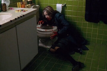 Ginger Snaps 2000 Movie Scene Katharine Isabelle as Ginger all bloody vomiting blood in the toilet