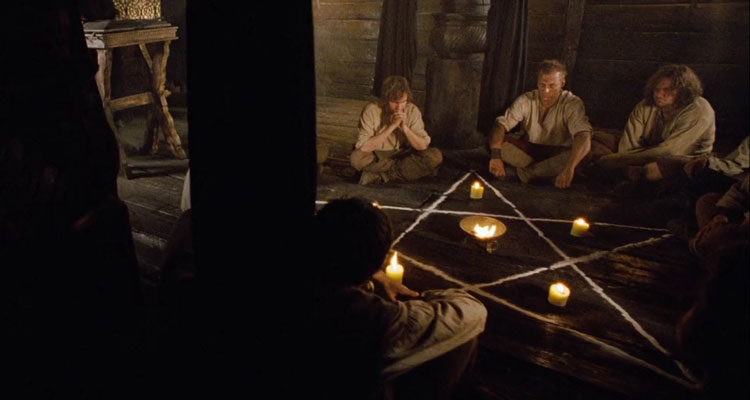 Krabat 2008 Movie Scene A group of boys sitting in a circle around a pentagram with candles lit inside