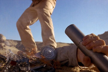 Screamers 1995 Movie Scene A severed hand holding a cylinder containing a message next to a dead robot