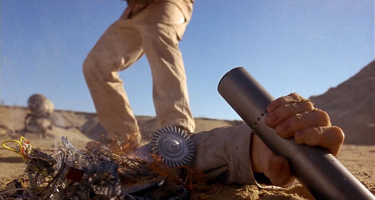 Screamers 1995 Movie Scene A severed hand holding a cylinder containing a message next to a dead robot