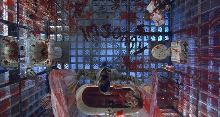 Thirteen Ghosts 2001 Movie Scene Bloody bathroom with a woman taking a bath in blood with the words I'm sorry written on the floor