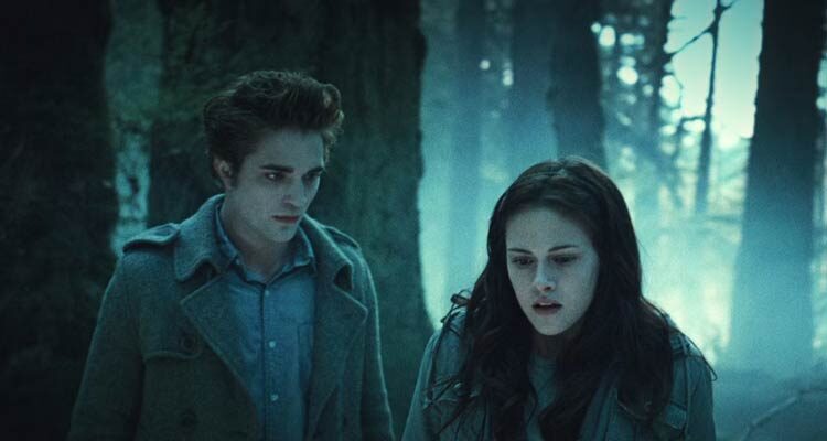 Twilight 2008 Movie Scene Robert Pattinson as Edward Cullen stalking Kristen Stewart as Bella Swan in a forest