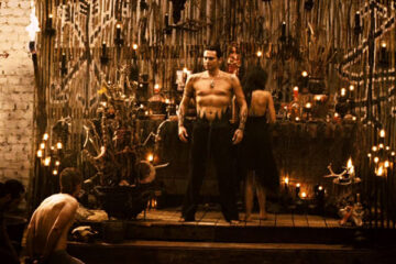 Borderland 2007 Movie Scene Cult leader standing on his throne half-naked and preparing for a ritual murder