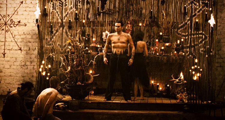 Borderland 2007 Movie Scene Cult leader standing on his throne half-naked and preparing for a ritual murder