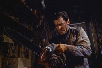 Evil Dead II 1987 Movie Scene Bruce Campbell as Ash fixing a chainsaw to his severed hand