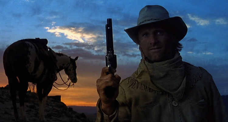 Hidalgo 2004 Movie Viggo Mortensen holding a gun with a horse in the background