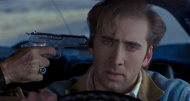 Red Rock West 1993 Movie Scene Nicolas Cage as Michael driving the car with a gun pointed to his head