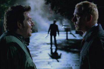 Shaun of the Dead 2004 Movie Scene Simon Pegg as Shaun and Nick Frost as Edgar returning drunk home from pub and not noticing zombies around them