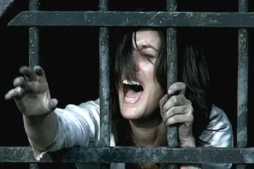 Them 2006 Movie Scene Olivia Bonamy as Clementine screaming after a hooded man starts chasing her in dark tunnels