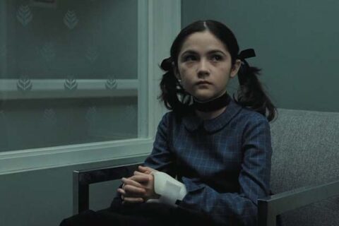 Orphan 2009 Movie Scene Isabelle Fuhrman as Esther sitting in a hospital waiting room after she tried to kill Daniel