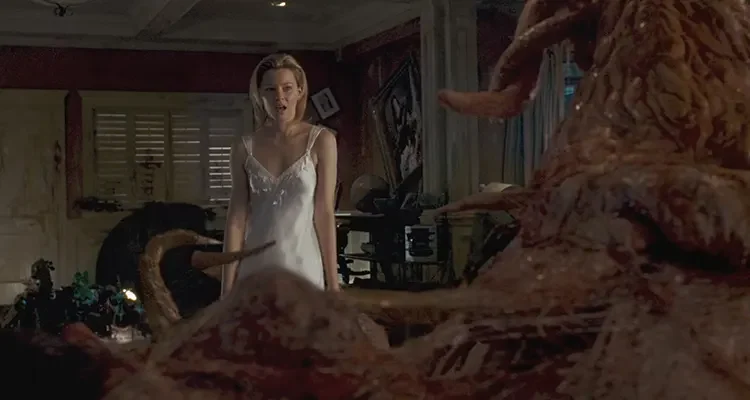 Slither 2006 Movie Scene Elizabeth Banks as Starla in a white nightgown disgusted by a strange and slimy creature