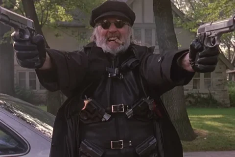 The Boondock Saints 1999 Movie Scene Billy Connolly as Il Duce holding two guns and smoking a cigar