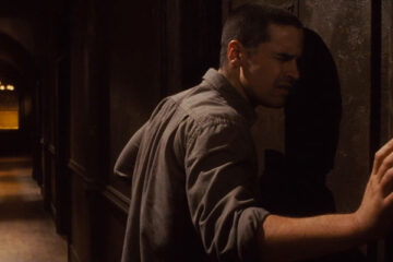 The Echo 2008 Movie Scene Jesse Bradford as Bobby Reynolds listening to strange sounds coming from the wall