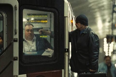 The Taking of Pelham 123 2009 Movie Scene John Travolta as Ryder holding a gun to subway train conductor's head and taking him hostage