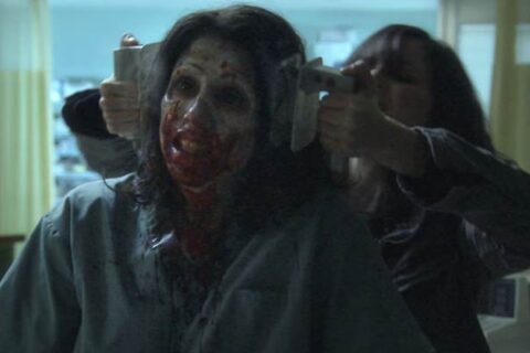 Diary of the Dead 2007 Movie Scene A young woman using shock pads to kill a zombie