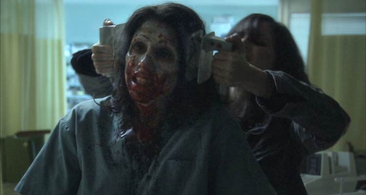 Diary of the Dead 2007 Movie Scene A young woman using shock pads to kill a zombie