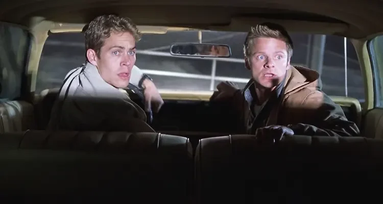 Joy Ride 2001 Movie Scene Steve Zahn as Fuller and Paul Walker as Lewis in their car trying to get away from a crazy trucker