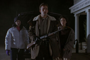 Phantoms 1998 Movie Scene Ben Affleck as Sheriff Bryce Hammond holding a shotgun with Joanna Going as Jennifer and Rose McGowan as Lisa standing behind him