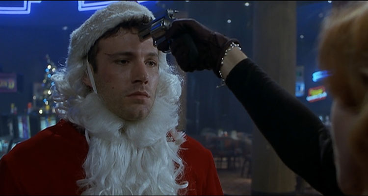 Reindeer Games 2000 Movie Scene Ben Affleck as Rudy dressed as a Santa with Charlize Theron as Ashley holding a gun to his head