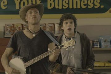 Zombieland 2009 Movie Scene Jesse Eisenberg as Columbus and Woody Harrelson as Tallahassee playing the banjo to draw out zombies in a supermarket