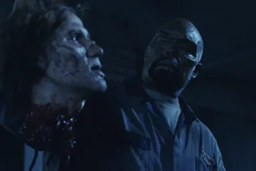 Land of the Dead 2005 Movie Scene Eugene Clark as Big Daddy, zombie leader holding the head of one of his zombie friends