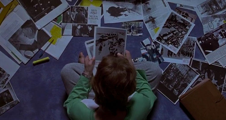 Apt Pupil 1998 Movie Scene Brad Renfro as Todd Bowden looking at pictures of Nazi crimes