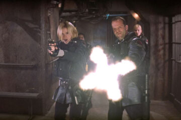 Ghosts Of Mars Movie 2001 Scene Jason Statham as Jericho firing off a machine gun at the demonically possesses miners