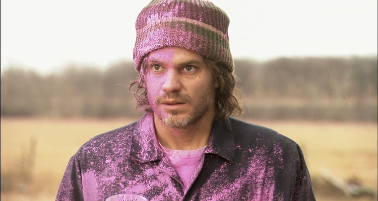 High Life 2009 Movie Timothy Olyphant as Dick covered in pink paint from the capsules in the money bag