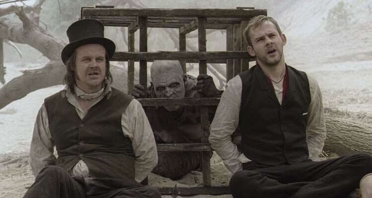 I Sell The Dead 2008 Movie Scene Dominic Monaghan as Arthur Blake and Larry Fessenden as Willy Grimes tied next to a cage with zombie in it