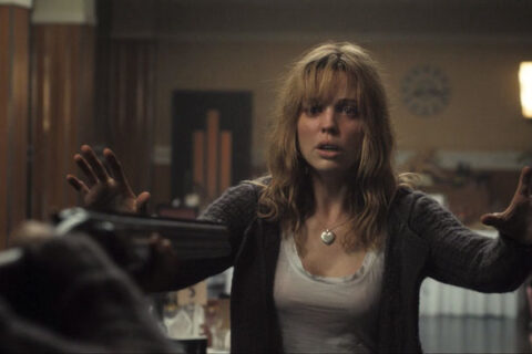 Triangle Movie 2009 Scene Melissa George as Jess with her arms in the air after someone pointing a shotgun at her