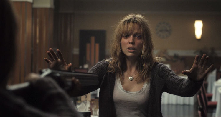 Triangle Movie 2009 Scene Melissa George as Jess with her arms in the air after someone pointing a shotgun at her