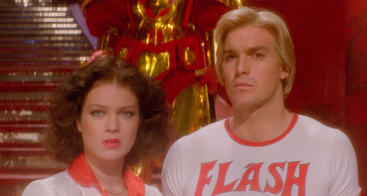 Flash Gordon 1980 Movie Scene Sam Jones as Flash Gordon wearing a t-shirt that says flash and Melody Anderson as Dale Arden