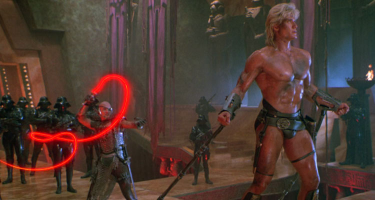 Masters of the Universe 1987 Movie Scene Dolph Lundgren as He-Man wearing only a jockstrap and in chains being whipped