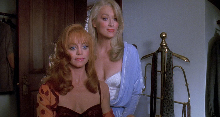 Death Becomes Her 1992 Movie Scene Meryl Streep as Madeline Ashton Menville and Goldie Hawn as Helen Sharp in revealing dresses offering a drink to Bruce Willis as Dr. Ernest Menville
